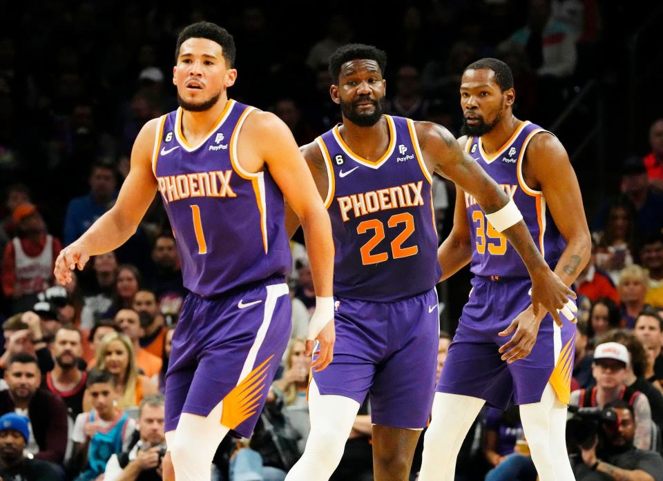 Phoenix Suns guard Devin Booker (1), center Deandre Ayton (22), and forward Kevin Durant (35) against the Minnesota Timberwolves in the first half at Footprint Center in Phoenix on March 29, 2023.