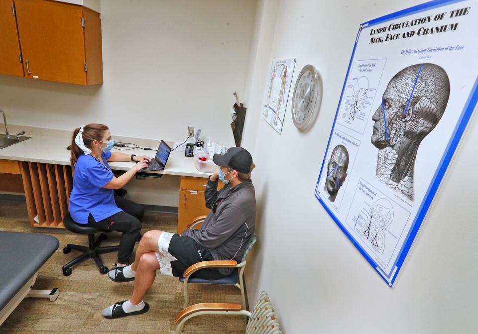 Physical Therapist Katherine Morin gets an update from Adam Bodony during a physical therapy session at IU Health North Hospital. Bodony is realistic. He says: ‘I may just have a constant headache or neck pain or burning pain for the rest of my life and I will just have to deal with it.’