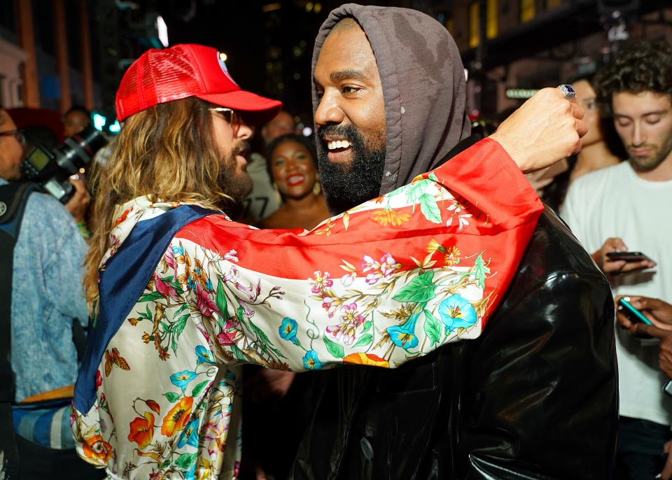 Actor Jared Leto (left) hugs Kanye West at a Vogue World event in New York earlier this fall. Vogue's editor Anna Wintour, once a Ye fan, recently announced that her magazine would no longer promote and cover the rapper.