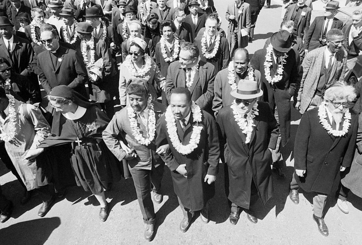 Martin Luther King, Jr. leads a group that includes a nun and Rabbi Abraham Joshua Heschel during the Selma to Montgomery Civil Rights march. <a href="https://www.gettyimages.com/detail/news-photo/dr-martin-luther-king-jr-arm-in-arm-with-his-chief-aide-rev-news-photo/517354530?adppopup=true" rel="nofollow noopener" target="_blank" data-ylk="slk:Bettmann via Getty Images;elm:context_link;itc:0;sec:content-canvas" class="link ">Bettmann via Getty Images</a>