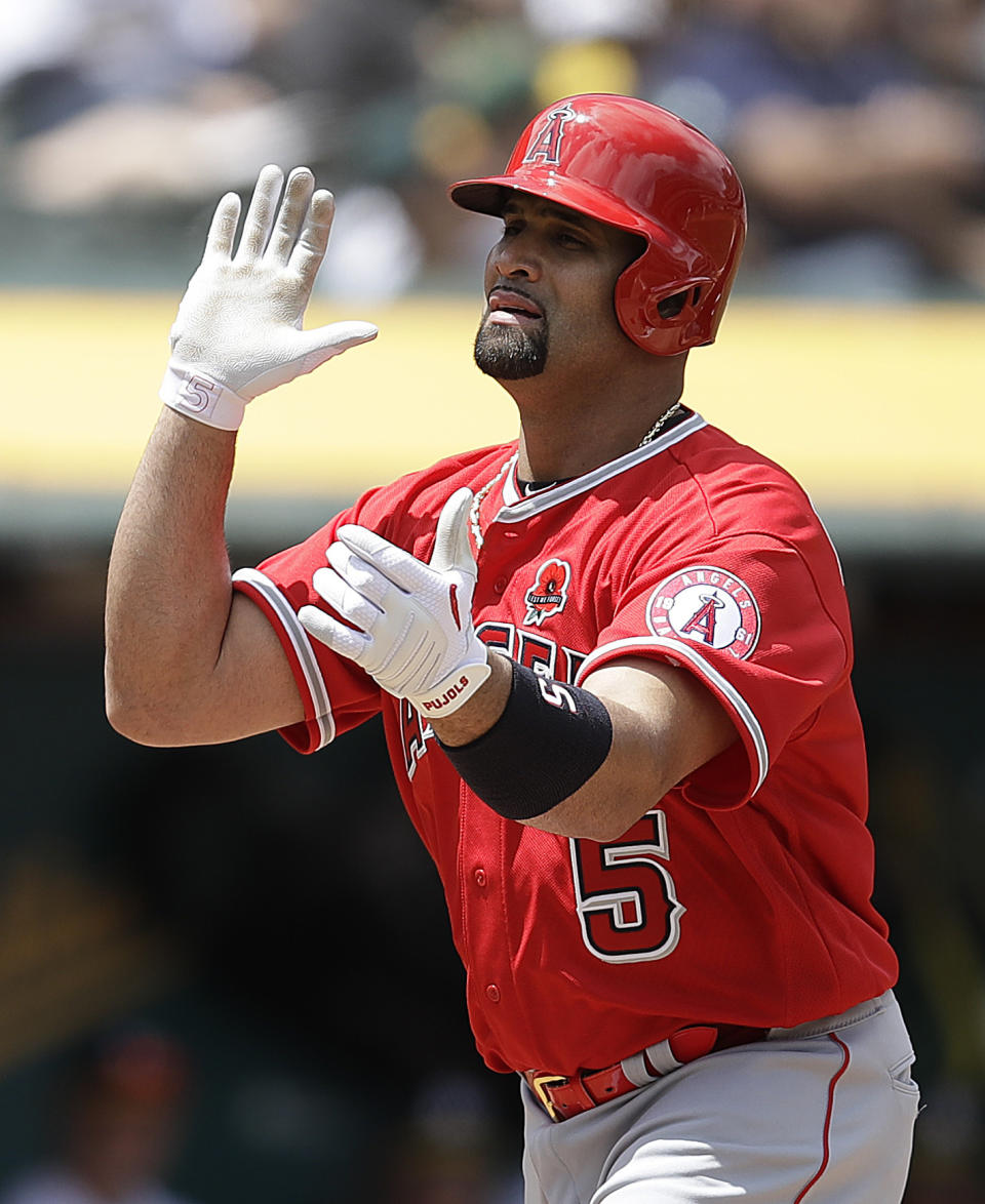 Los Angeles Angels' Albert Pujols celebrates after hitting a home run off Oakland Athletics' Chris Bassitt in the fourth inning of a baseball game Monday, May 27, 2019, in Oakland, Calif. (AP Photo/Ben Margot)