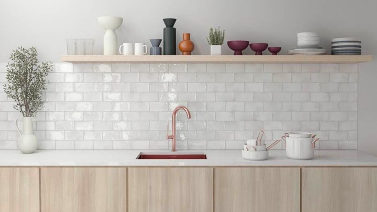  A kitchen sink counter with pearly white tile backsplash 