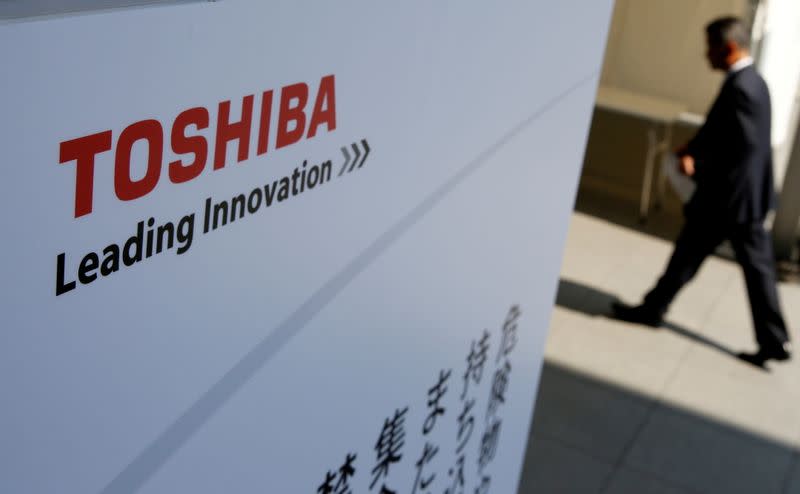 FILE PHOTO: The logo of Toshiba is seen as a shareholder arrives at an extraordinary shareholders meeting in Chiba, Japan