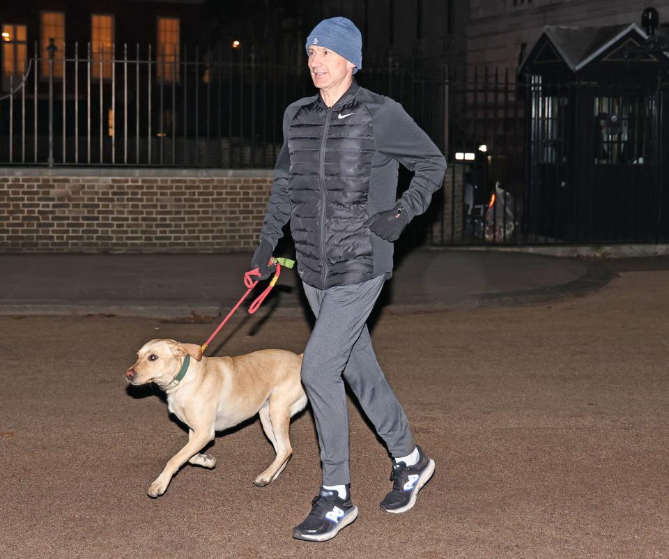 Jeremy Hunt, the Chancellor, is seen running with his dog Poppy in Westminster this morning - Nigel Howard Media