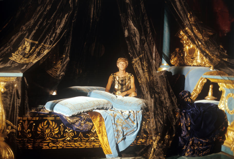 British actor Malcolm McDowell (Malcolm John Taylor) playing the role of the Emperor Caligula sitting on a bed in the film Caligula, My Son. 1979. (Photo by Mondadori via Getty Images)