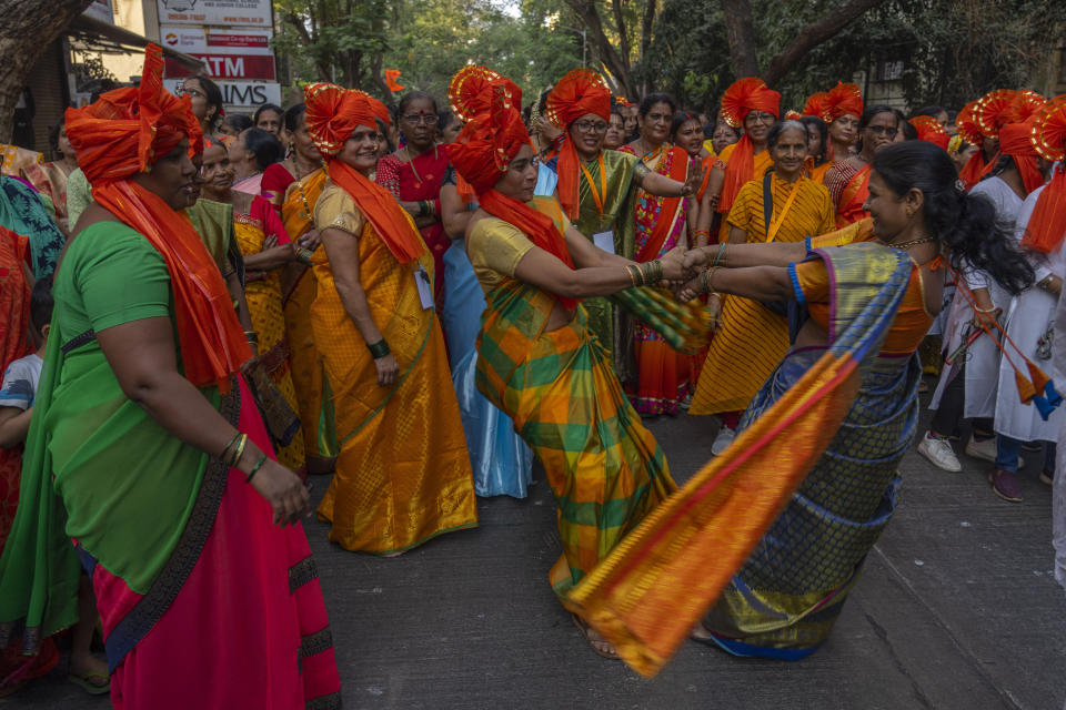 Hindu women dance to celebrate the upcoming opening of a grand temple for the Lord Ram, in India's northern Ayodhya city during a procession in Mumbai, India, Sunday, Jan. 21, 2024. (AP Photo/Rafiq Maqbool)