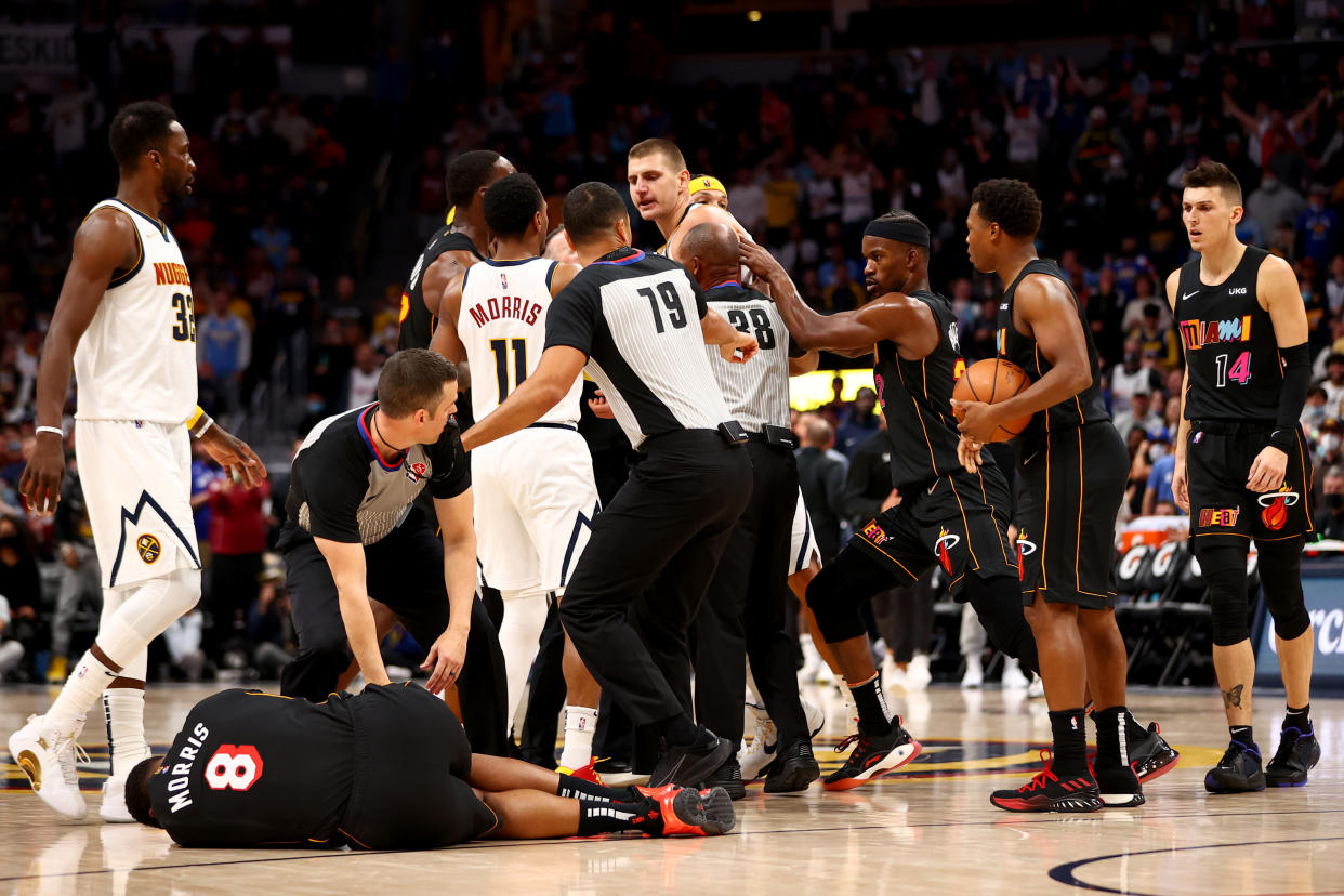 DENVER, CO - NOVEMBER 08: Markieff Morris #8 of the Miami Heat lays on the ground after being hit by Nikola Jokic #15 of the Denver Nuggets at Ball Arena on November 8, 2021 in Denver, Colorado. NOTE TO USER: User expressly acknowledges and agrees that, by downloading and or using this photograph, User is consenting to the terms and conditions of the Getty Images License Agreement. (Photo by Jamie Schwaberow/Getty Images)