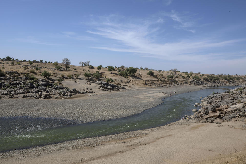 FILE - In this Dec. 15, 2020 file photo, a general view of the empty banks of the Tekeze River, on the Sudan-Ethiopia border after Ethiopian forces blocked Tigrayan refugees from crossing into Sudan, in Hamdayet, eastern Sudan. Ethiopia is at left, and Sudan is on the right. Dozens of bodies have been found floating down the Setit River, known in Ethiopia as Tekeze River, in southwestern Sudan in the past week, Wednesday, Aug. 4, 2021. (AP Photo/Nariman El-Mofty)