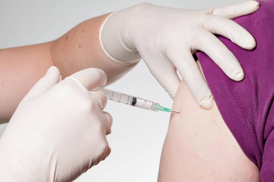 Patient bekommt eine Impfung per Spritze in den Oberarm