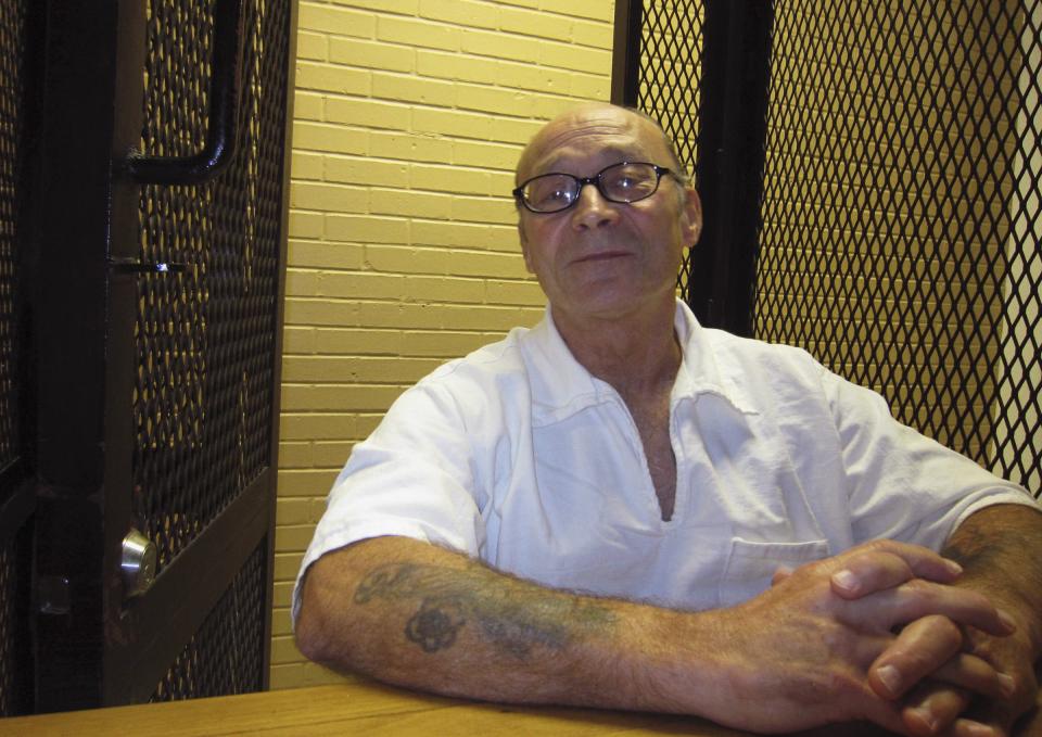 Inmate Arnold Darby speaks during an interview in a holding area at the Goree Unit prison in Huntsville, Texas December 5, 2013. Darby was once one of the most prodigious bootmakers in the Texas prison system, turning out more than 1,000 pairs for lawman, FBI agents and the governor's office. After 37 years behind bars, serving time for robbery and murder, Darby was released on parole in 2011. After only a year on the outside, Darby violated parole by driving while intoxicated and was sent back to prison. This time, however, he has not been in the new unit long enough to earn what is considered a privileged position in a workshop, and the once-vaunted jailhouse cobbler is not sure if he will ever make boots again. Picture taken December 5, 2013. TO MATCH FEATURE USA-PRISONER/BOOTS REUTERS/Jon Herskovitz (UNITED STATES - Tags: CRIME LAW)