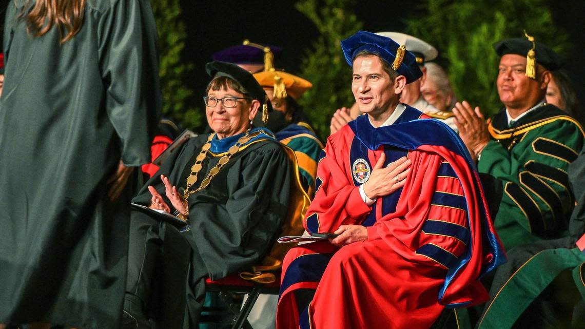 Dr. Saúl Jiménez-Sandoval gestures toward Belinda Munoz, chair for the staff assembly at Fresno State after her speech during Jiménez-Sandoval’s investiture ceremony to formally become Fresno State’s ninth president at the Save Mart Center on Friday, Sept. 9, 2022.