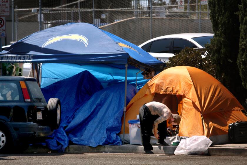 VENICE, CA - JULY 10, 2024 - Homeless live along 200 Grand Canal Street a block from where the Venice Dell Project is to be built as housing for the homeless in Venice on July 10, 2024. Advocates for low-income housing are suing the city of Los Angeles this week accusing City Council member Traci Park, City Atty. Hydee Feldstein Soto and other officials of violating fair housing laws by allegedly blocking a planned affordable housing development in Venice. The Venice Dell project is to include 140 units of housing for low-income and formerly homeless residents on what's now a city-owned parking lot along the neighborhood's famed canals. (Genaro Molina/Los Angeles Times)