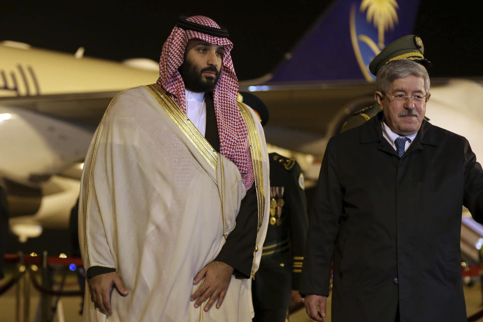 Saudi Crown Prince Mohammed bin Salman, left, is greeted by Algerian Prime Minister Ahmed Ouyahia upon his arrival at Algiers international airport, Algeria, Sunday, Dec. 2, 2018. Algeria's presidency says Saudi Crown Prince Mohammed bin Salman will start a two-day visit to Algeria Sunday with a focus on economic ties between the two countries. (AP Photo/Anis Belghoul)