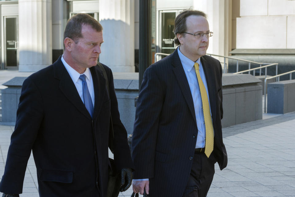 Former West Virginia Supreme Court Justice Allen Loughry, right, emerges with his lawyer John Carr from the Robert C. Byrd United States Courthouse after his sentencing, Wednesday, Feb. 13, 2019 in Charleston, W.Va. Loughry, a former West Virginia Supreme Court justice who had a $32,000 blue suede couch in his office and was at the center of an impeachment scandal has been sentenced to two years behind bars. (Craig Hudson/Charleston Gazette-Mail via AP)