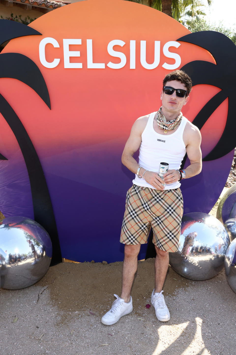 Barry Keoghan, coachella 2024 worst dressed, celsius party, burberry shorts and bandana, versace tank top, nike sneakers