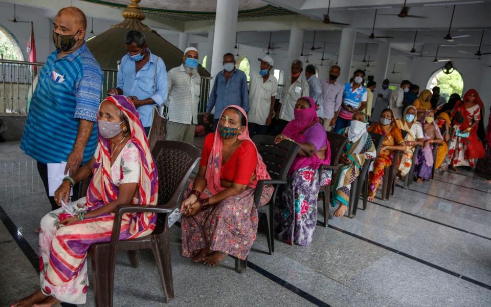 People wait to get vaccinated against Covid-19 at a mosque in Ahmedabad, India on June 21 2021 - Ajit Solanki/AP