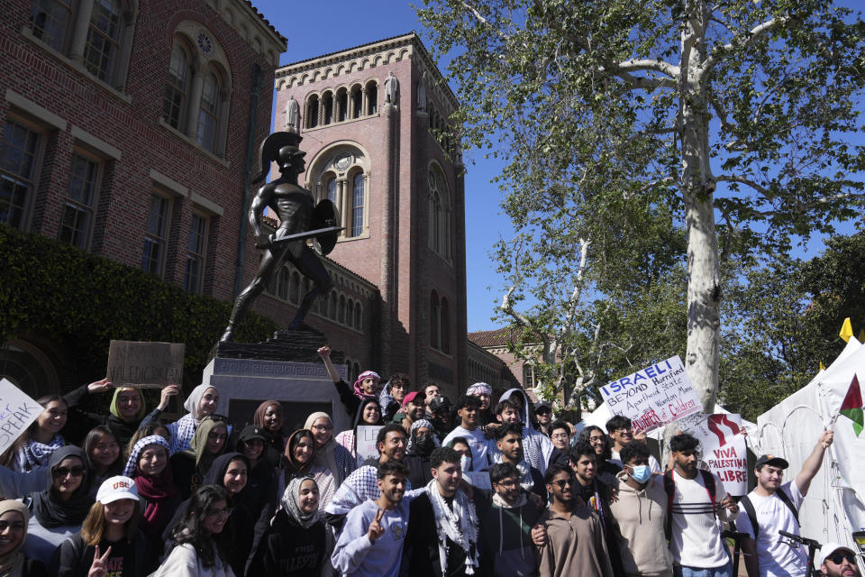 Pro-Palestinian students pose for photos in front of the Tommy Trojan statue on the campus of the University of Southern California during a protest of the 2024 valedictorian Asna Tabassum canceled commencement speech on Thursday, April 18, 2024. The University of Southern California canceled the commencement speech by its 2024 valedictorian who has publicly supported Palestinians, citing security concerns, a rare decision that was praised by several pro-Israel groups and lambasted by free speech advocates and the country's largest Muslim civil rights organization. (AP Photo/Damian Dovarganes)