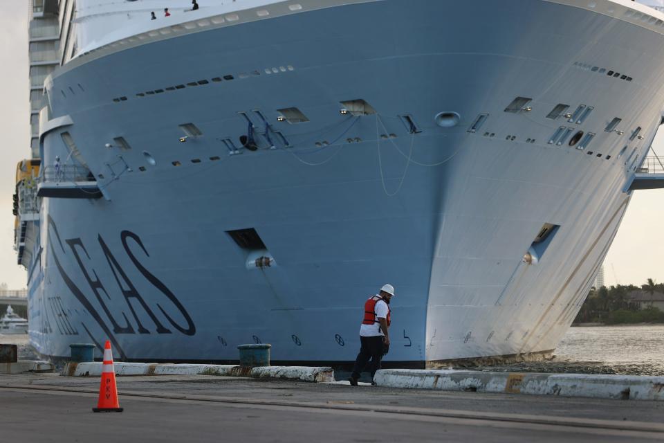 A dock worker waits for the Royal Caribbean’s Odyssey of the Seas to pull into its berthing spot at Port Everglades on June 10, 2021, in Fort Lauderdale, Florida. Odyssey of The Seas will hold its first passenger cruise on July 3 through the Caribbean.