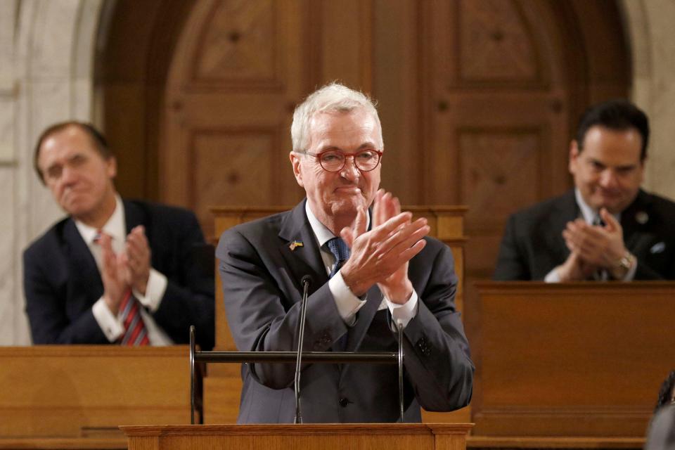 Gov. Phil Murphy applauds during his delivery of the State of the State address to a joint session of the Legislature in the Assembly Chamber at the Statehouse in Trenton Tuesday, january 9, 2024. Behind him are Assembly Speaker Craig Coughlin and state Senate President Nick Scutari.