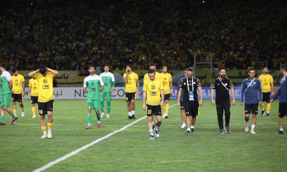 Sepahan players leave the pitch after the match against Al-Ittihad was called off.