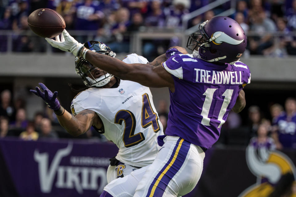 <p>Baltimore Ravens cornerback Brandon Carr (24) intercepts a pass intended for Minnesota Vikings wide receiver Laquon Treadwell (11) during the first quarter at U.S. Bank Stadium. Mandatory Credit: Brace Hemmelgarn-USA TODAY Sports </p>