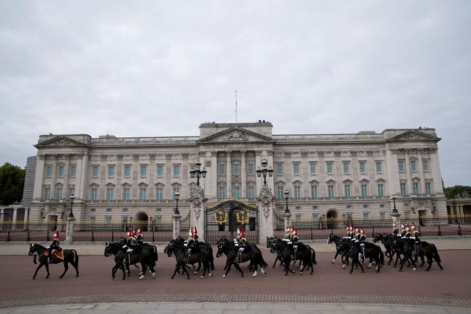 Soldiers on horseback ride past Buckingham Palace.<span class="copyright">Christophe Ena—Pool/Reuters</span>