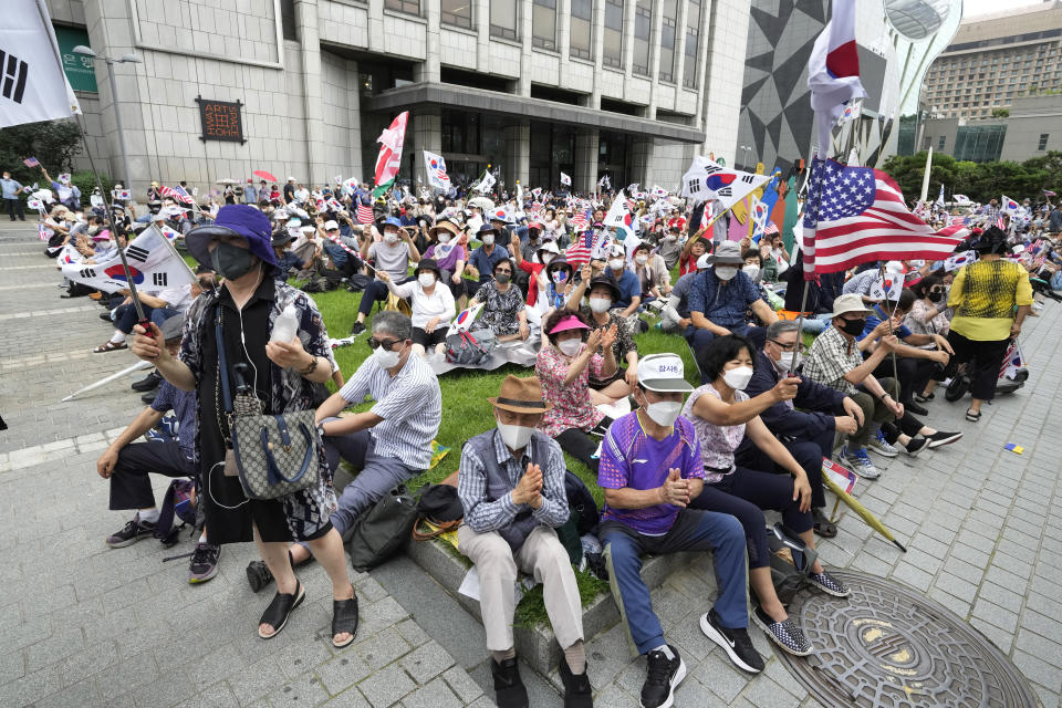 People attend a rally against North Korea on Korea's Liberation Day in Seoul, South Korea, Monday, Aug. 15, 2022. South Korean President Yoon Suk Yeol on Monday offered "audacious" economic assistance to North Korea if it abandons its nuclear weapons program while avoiding harsh criticism of the North days after it threatened "deadly" retaliation over the COVID-19 outbreak it blames on the South. (AP Photo/Ahn Young-joon)