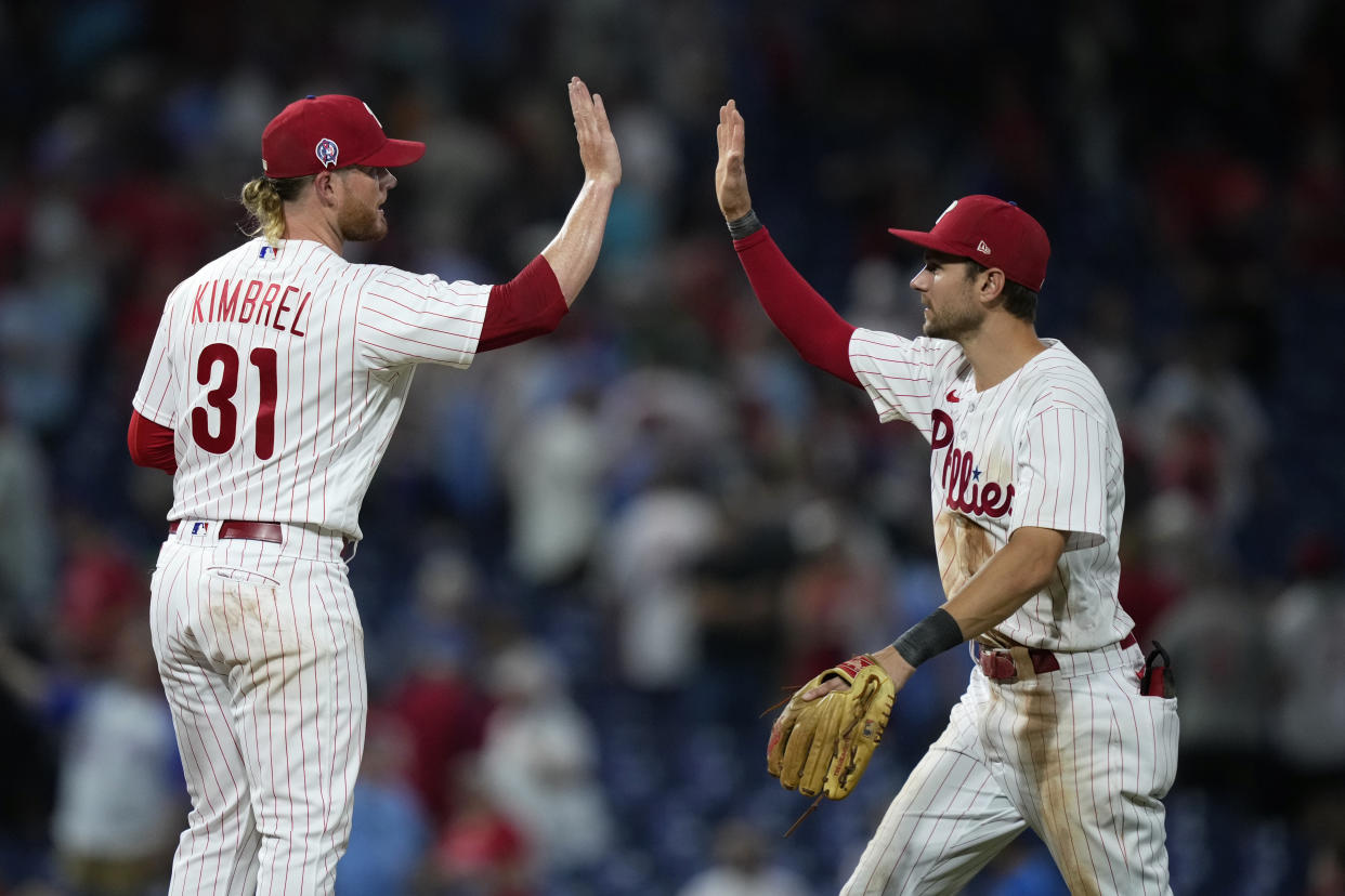 The Philadelphia Phillies' Craig Kimbrel, left, and Trea Turner celebrate after the Phillies won the second game of a doubleheader against the Braves on Monday. (AP Photo/Matt Slocum)