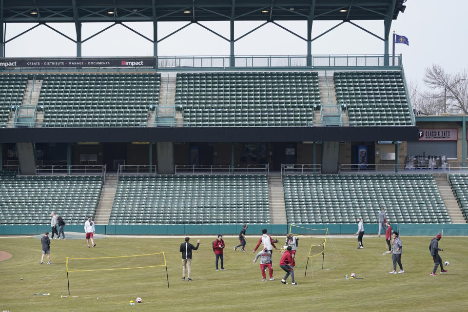 The Arkansas basketball team enjoys some outside activity at Victory Field at the NCAA college basketball tournament, Wednesday, March 17, 2021, in Indianapolis. (AP Photo/Darron Cummings)