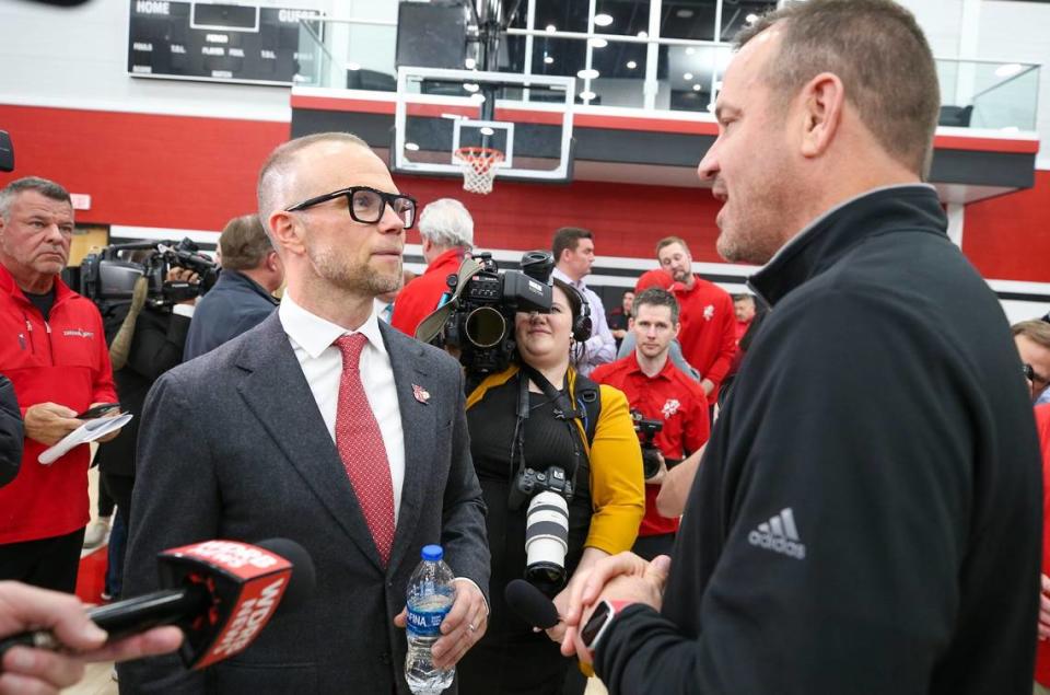 New Louisville men’s basketball coach Pat Kelsey, left, is greeted by U of L women’s basketball coach Jeff Walz after Kelsey was introduced on Thursday.
