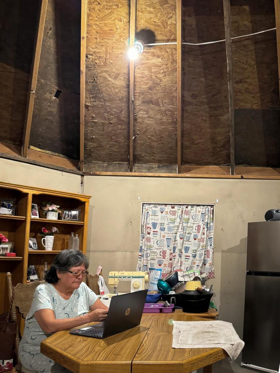 PHOTO: Eleanor Paddock sits under a light in her home in Navajo Nation after being connected to solar power. (Dan Manzo/ABC News)