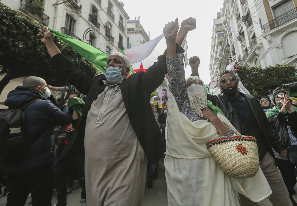 People demonstrate with Algerian flags for a second time this week in Algiers, Algeria, Feb. 26, 2021. Algerians turned out on Friday in the streets of the capital and scattered cities around their North African country to demonstrate in the pro-democracy movement, four days after tens of thousands of marchers marked Hirak's second anniversary. (AP Photo/Anis Belghoul)