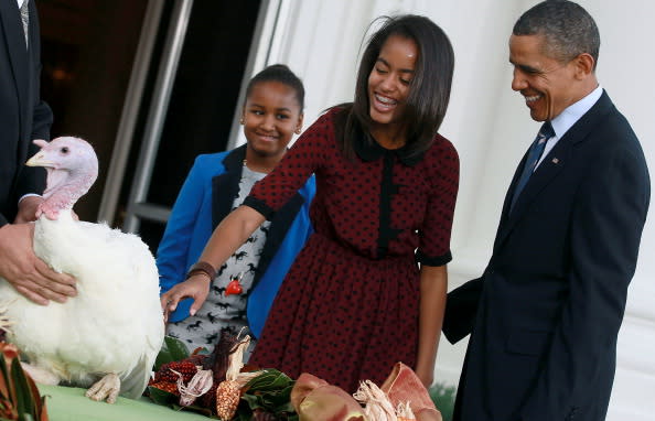 U.S. President Barack Obama is flanked by his daughters Sasha (L) and Malia (R) after pardoning 'Liberty', a 19-week old, 45-pound turkey at the North Portico of the White House November 23, 2011 in Washington, DC. The Presidential pardon of a turkey has been a long time Thanksgiving tradition that dates back to the Harry Truman administration. (Photo by Mark Wilson/Getty Images)