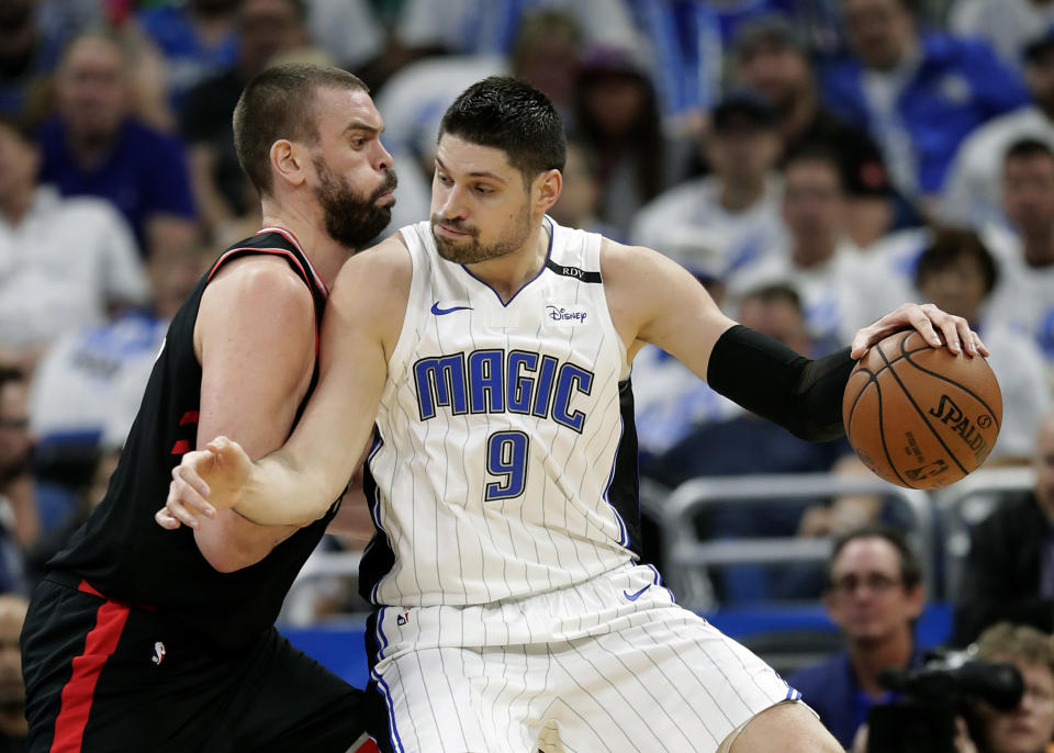 Orlando Magic's Nikola Vucevic (9) tries to get past Toronto Raptors' Marc Gasol during the first half in Game 3 of a first-round NBA basketball playoff series, Friday, April 19, 2019, in Orlando, Fla. (AP Photo/John Raoux)