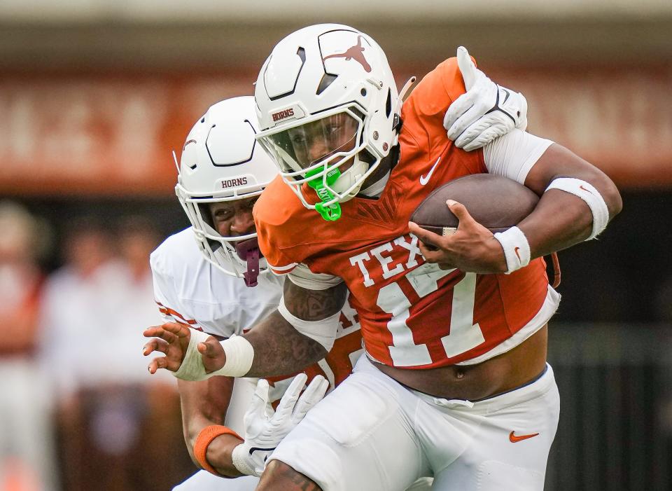 Texas running back Savion Red evades a tackler during Saturday's Orange-White spring game at Royal-Memorial Stadium. Used primarily in Texas' wildcat formation last season, Red has entered the transfer portal.