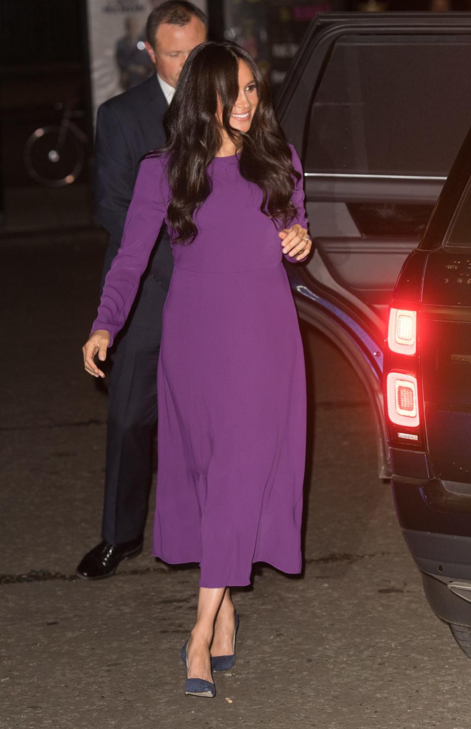 Meghan Markle wearing a purple dress.