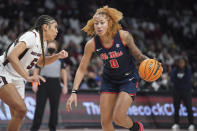 Mississippi forward Shakira Austin (0) dribbles against South Carolina forward Victaria Saxton (5) during the first half of an NCAA college basketball game Thursday, Jan. 27, 2022, in Columbia, S.C. (AP Photo/Sean Rayford)