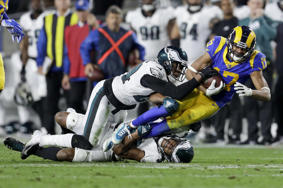 Los Angeles Rams wide receiver Robert Woods, right, is tackled by Philadelphia Eagles free safety Corey Graham, top, and cornerback Cre'von LeBlanc during the first half in an NFL football game Sunday, Dec. 16, 2018, in Los Angeles. (AP Photo/Marcio Jose Sanchez)