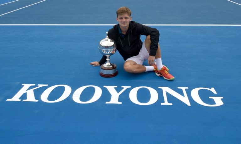 David Goffin of Belgium poses with the trophy after beating Feliciano Lopez of Spain in the men's singles final of the Kooyong Classic in Melbourne, on January 15, 2016