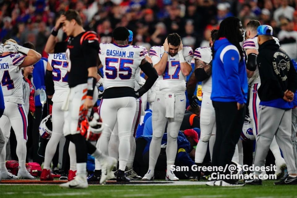 Players react as medical personnel attend to Bills defensive back Damar Hamlin.

Bills React