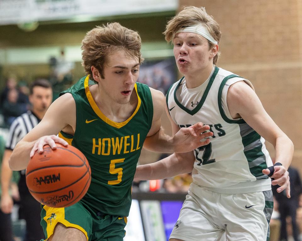Howell's Logan Leppek, who scored a career-high 20 points, drives past Williamston's Anthony Schellie during the Highlanders' 64-49 victory on Tuesday, Dec. 6, 2022.