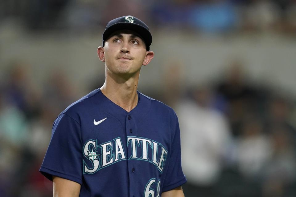 Seattle Mariners starting pitcher George Kirby walks to the dugout after being pulled in the sixth inning of a baseball game against the Texas Rangers in Arlington, Texas, Friday, Aug. 12, 2022. (AP Photo/Tony Gutierrez)