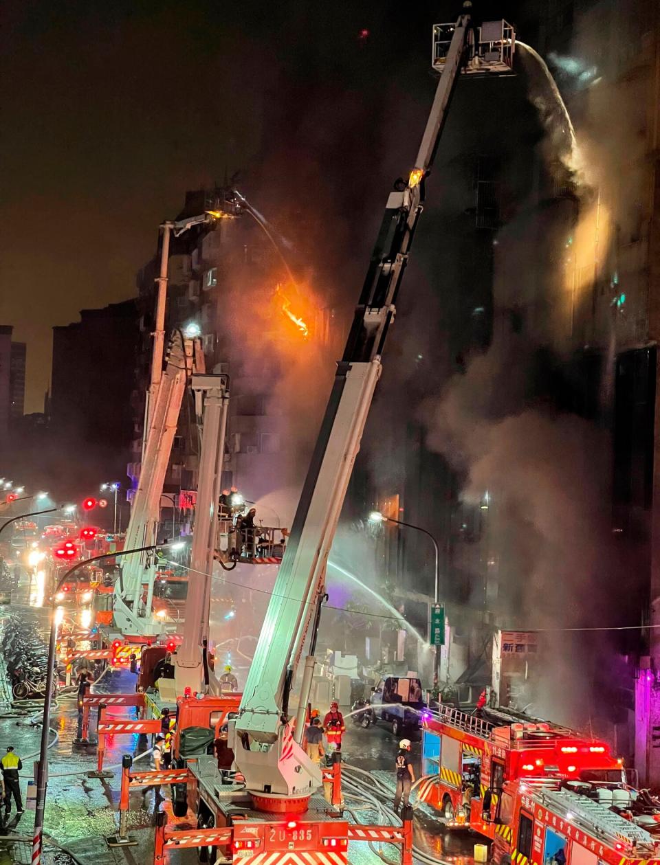 Firefighters battle a building fire in Kaohsiung