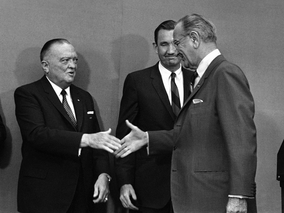 President Lyndon B. Johnson and J. Edgar Hoover are about to shake hands as Attorney General Ramsey Clark looks on at the White House in Washington, DC.