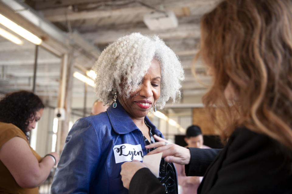 A woman putting a name tag on another woman