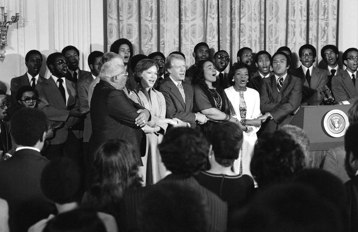 FILE – The White House was the scene of a reception to honor friends of the Martin Luther King Jr. Center for Social Change in Washington on Oct. 3, 1978. Singing at the reception are from left, Dr. Martin Luther King Sr., Rosalynn Carter, President Jimmy Carter, Coretta Scott King, Christine Parris King, sister of the late Dr. King, and Andrew Young, U.N. Ambassador. (AP Photo/Barry Thumma, File)