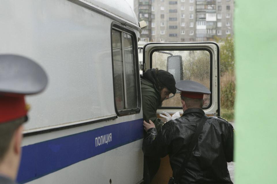 Handout shows Greenpeace International activist from Canada, arrested for staging a protest at Russia's first Arctic offshore oil platform, arriving at the Leninsky District Court in Murmansk