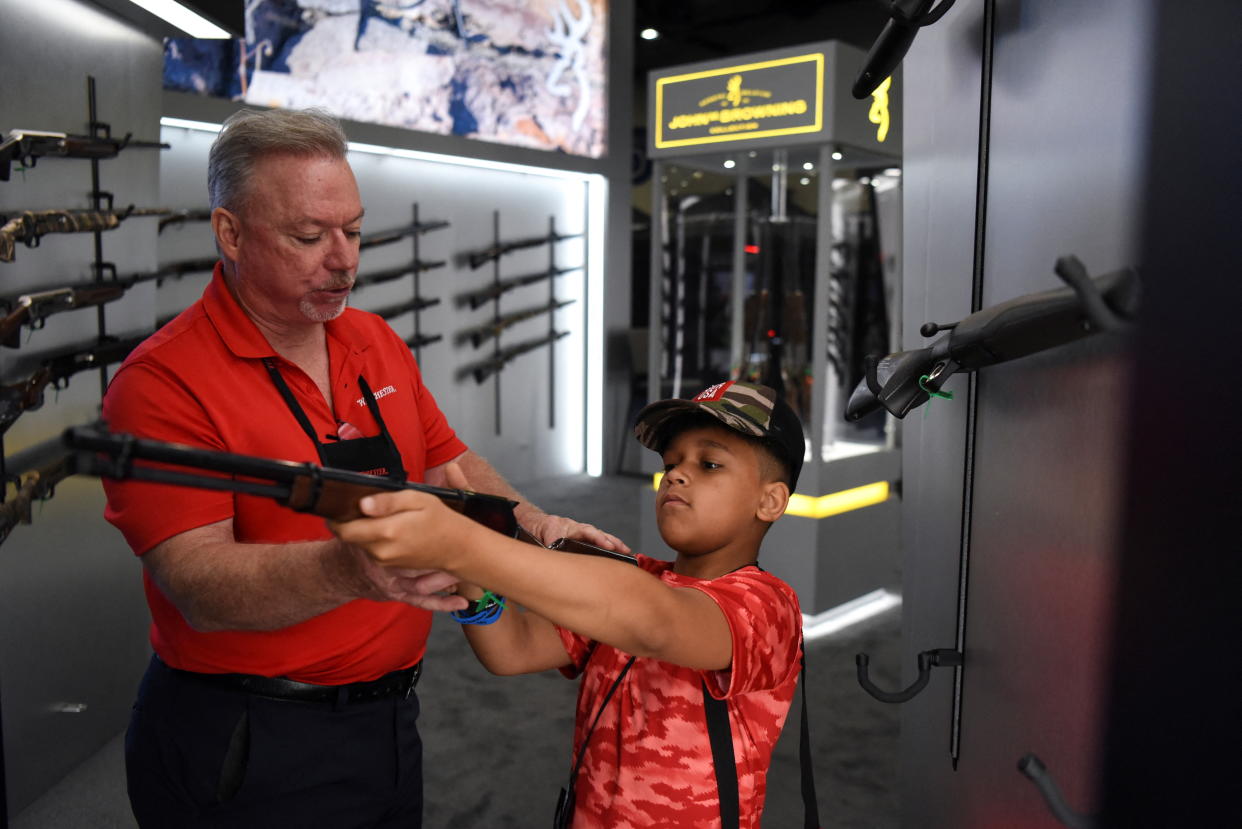 A child holds a firearm on display at the National Rifle Association (NRA) annual convention in Houston, Texas, U.S. May 29, 2022. REUTERS/Callaghan O'Hare