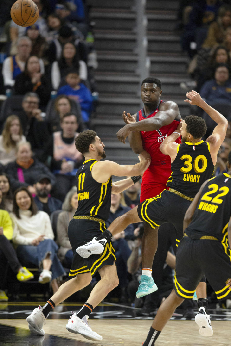 New Orleans Pelicans forward Zion Williamson (1) passes the ball over Golden State Warriors defenders Klay Thompson (11) and Stephen Curry (30) during the second quarter of an NBA basketball game, Wednesday, Jan. 10, 2024, in San Francisco. (AP Photo/D. Ross Cameron)