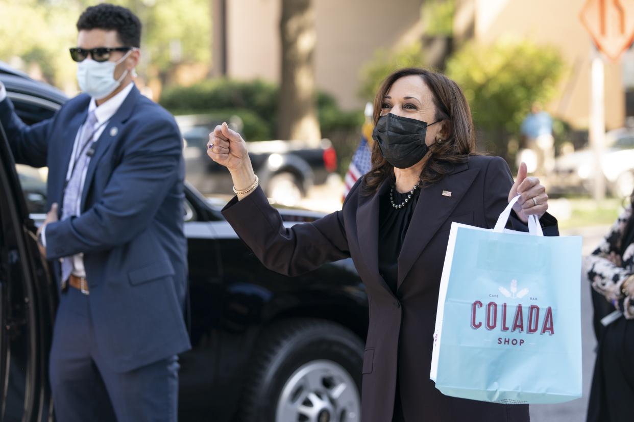 Vice President Kamala Harris reacts to people waving as she exits The Colada Shop, a Latina owned coffee shop, Monday, Oct. 4, 2021, in Washington. (AP Photo/Jacquelyn Martin)